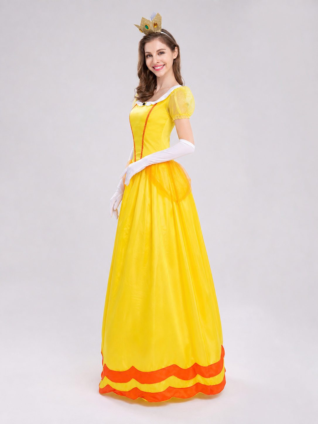 The princess costume features a festive style with distinctive details. The look is centered around a yellow dress with a fitted bodice and full skirt. Symmetrical orange decorative lines on the chest accent the bodice design. A white colla
