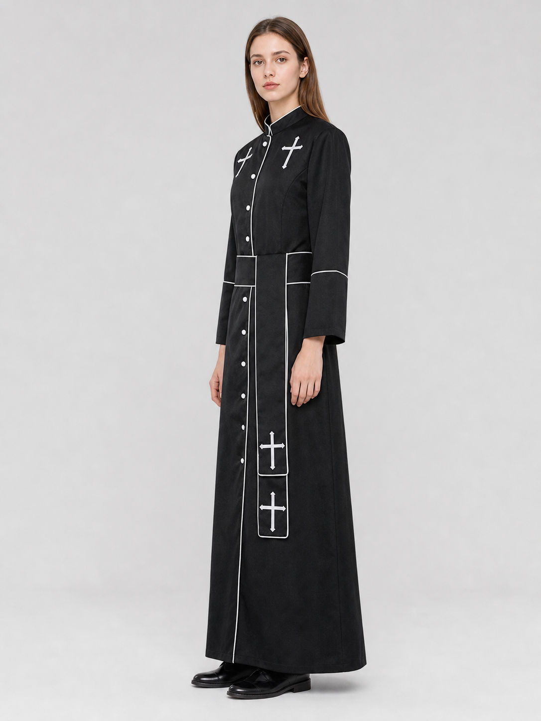The model is designed in black and styled as a costume for cosplay, Halloween, and masquerades. It is a black cassock with a front featuring white buttons, a stand-up collar, and long sleeves. White crosses are placed on the garment: one is