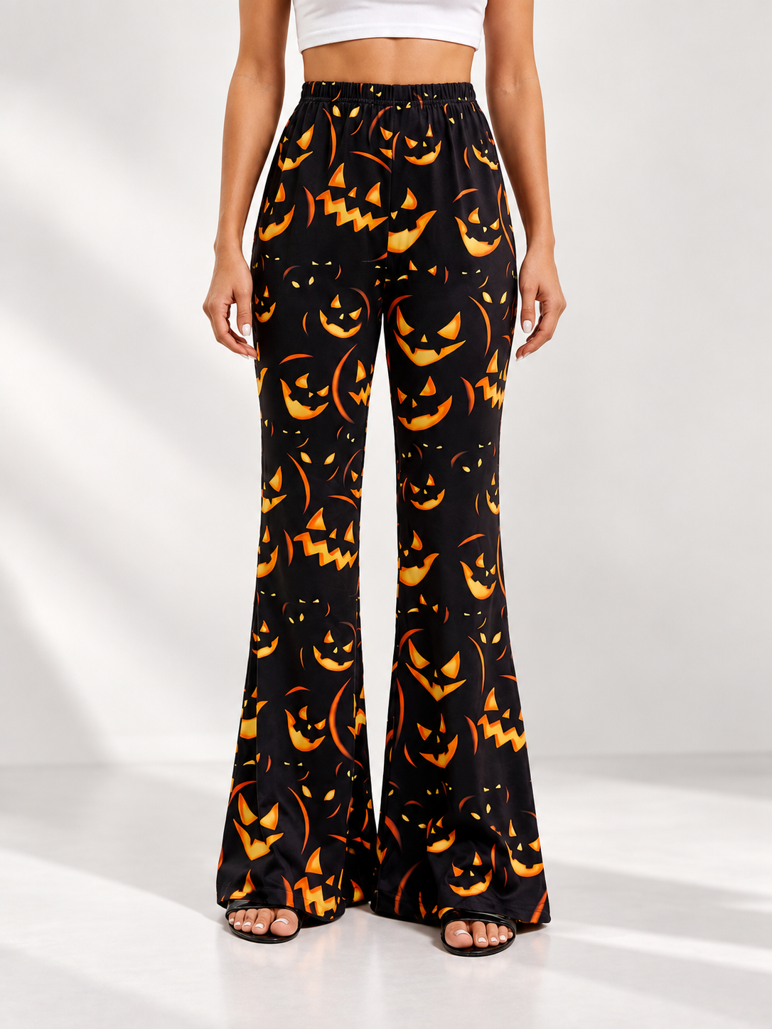 Black Flared Carnival Pants with Orange Smiling Pumpkin Print