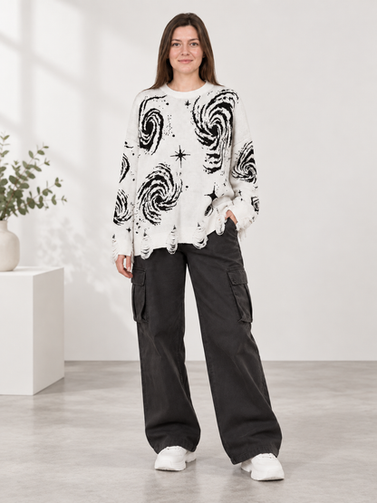 white oversized sweater with black star and spiral print