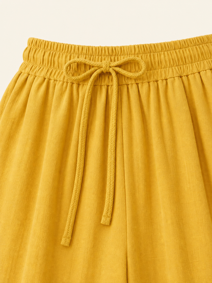 Mustard-colored wide-leg pants with long pant legs