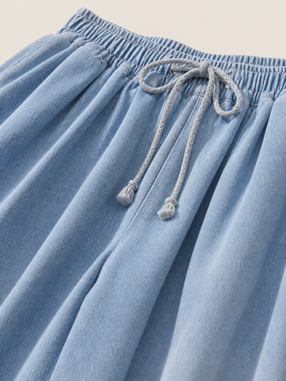 The model features a relaxed style with very wide, full-length legs that create