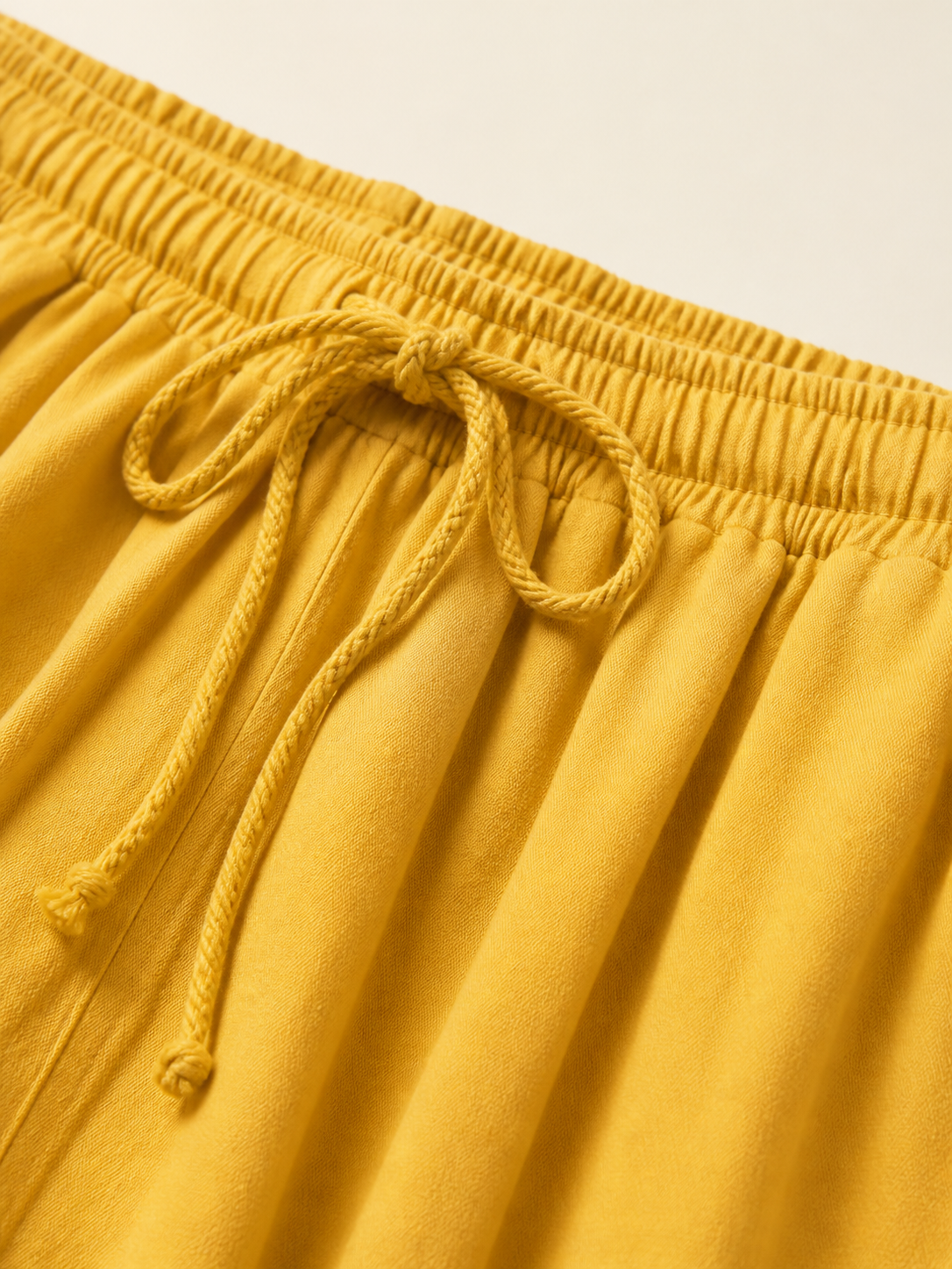 Mustard-colored wide-leg pants with long pant legs