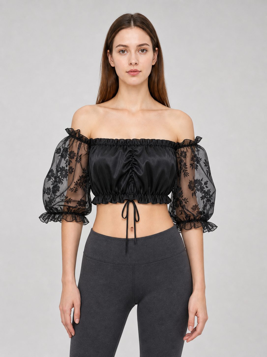 The blouse is black: the main body is made of opaque, smooth fabric