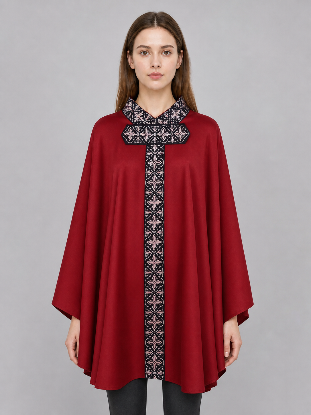The cape is red with black decorative elements. It has a loose cloak-style silhouette, wide sleeves, and a collar with black patterned detailing. The front features a vertical decorative stripe down the center and a horizontal stripe across