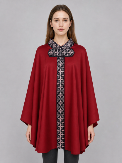 The cape is red with black decorative elements. It has a loose cloak-style silhouette, wide sleeves, and a collar with black patterned detailing. The front features a vertical decorative stripe down the center and a horizontal stripe across