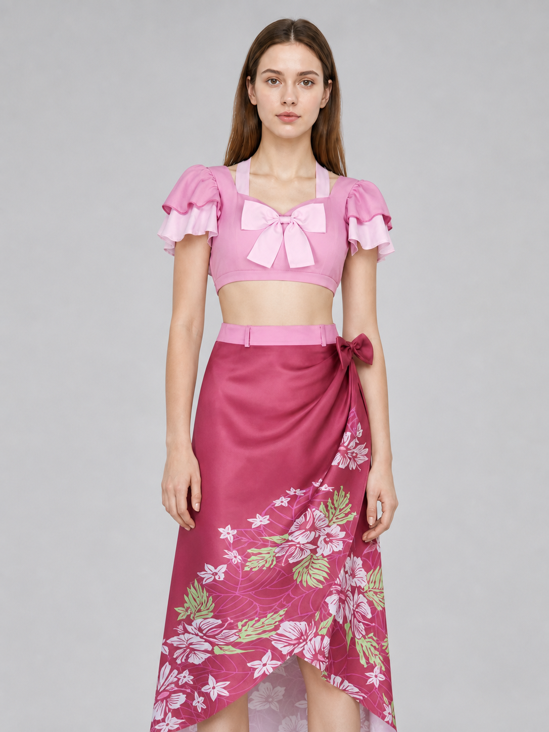This cosplay set is designed as a short-sleeve crop top and a long skirt. It includes a top, a half-skirt, and decorative bows. There is a bow on the chest of the top, and another bow is placed on the side of the skirt waist. The top has an