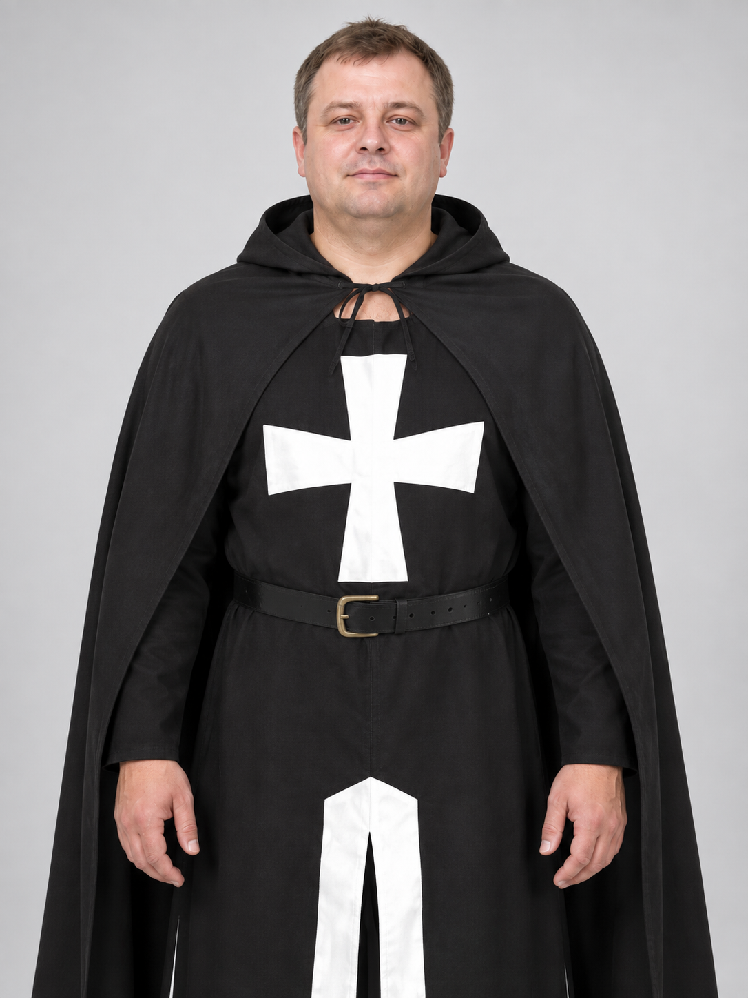 Black costume with white cross, hood, and belt