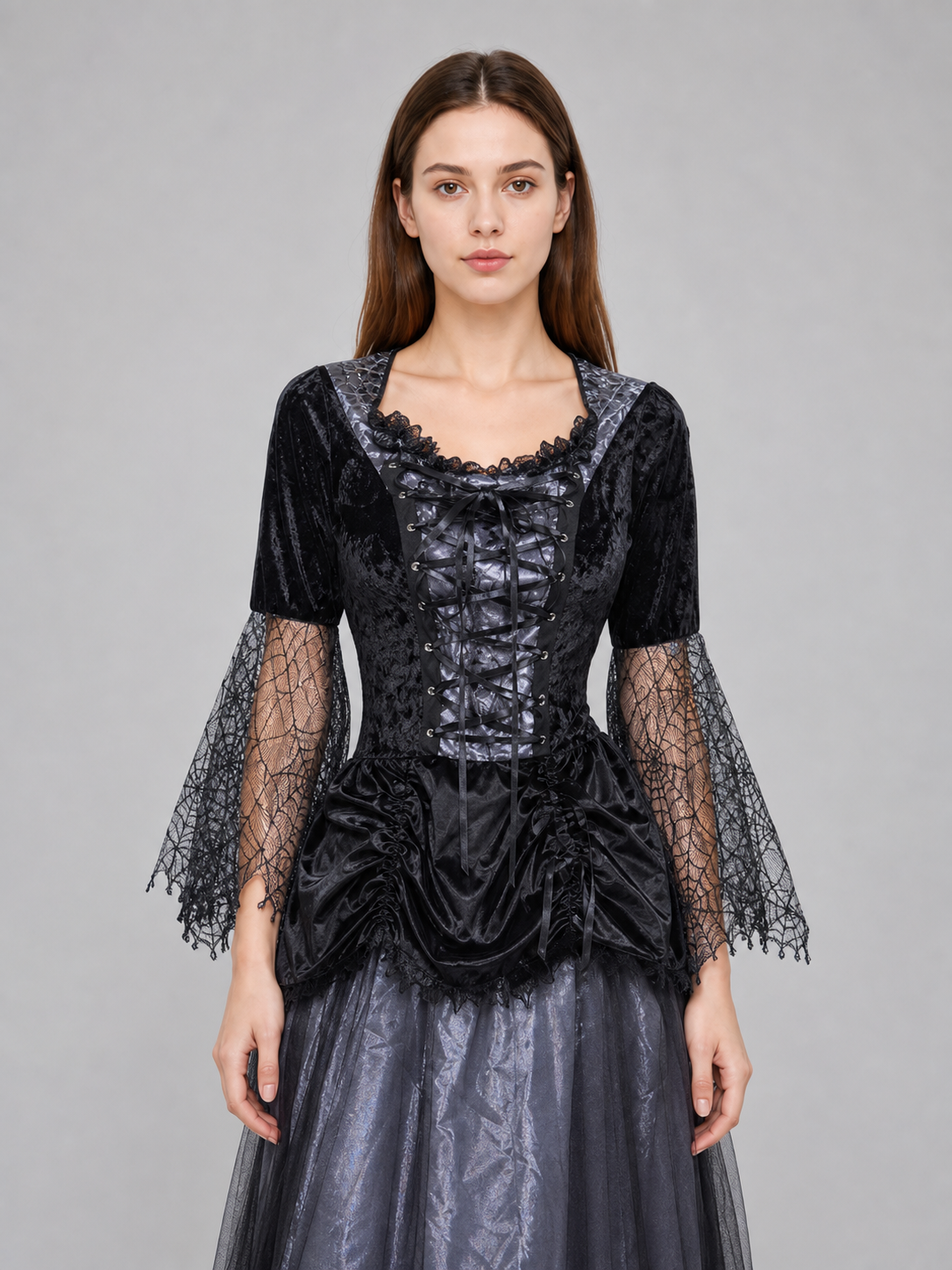 Gothic-style witch costume dress with hat for themed events. The design is mainly black and dark gray, with patterned textured fabric and sheer black accents. The look is centered on a long dress with a fitted lace-up corset, a ruffled neck