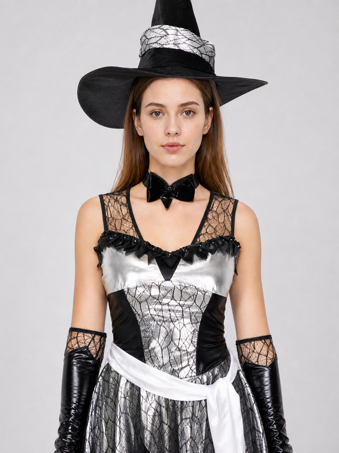 The witch costume is designed in a black, silver, and white color scheme and Costumes detail