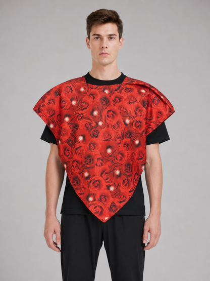 Bright heart-shaped costume with a floral print. A voluminous silhouette with a pointed lower edge and wide short sleeves that extend from the sides of the garment. The surface is decorated with an allover floral pattern reminiscent of rose