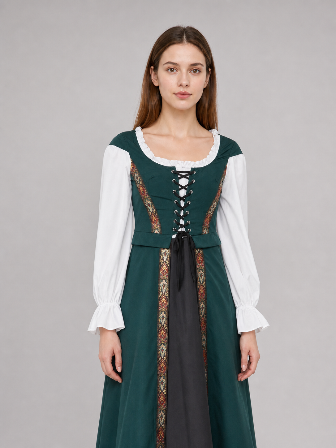The retro dress is designed in a courtly style and comes with a woven headpiece. The dress is presented in deep green with long white sleeves, white trim along the edge of the collar and cuffs, and crisscross lacing at the front that emphas
