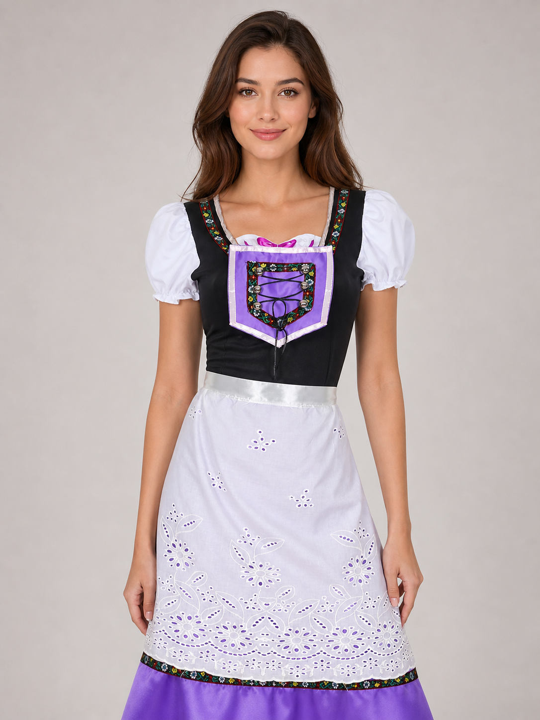 The dress is designed in an ethnic style and features a contrasting combination of white, pink, purple, and black. It has a black bodice, voluminous white puff sleeves, and a white waistband. The front is decorated with a purple lace-up det