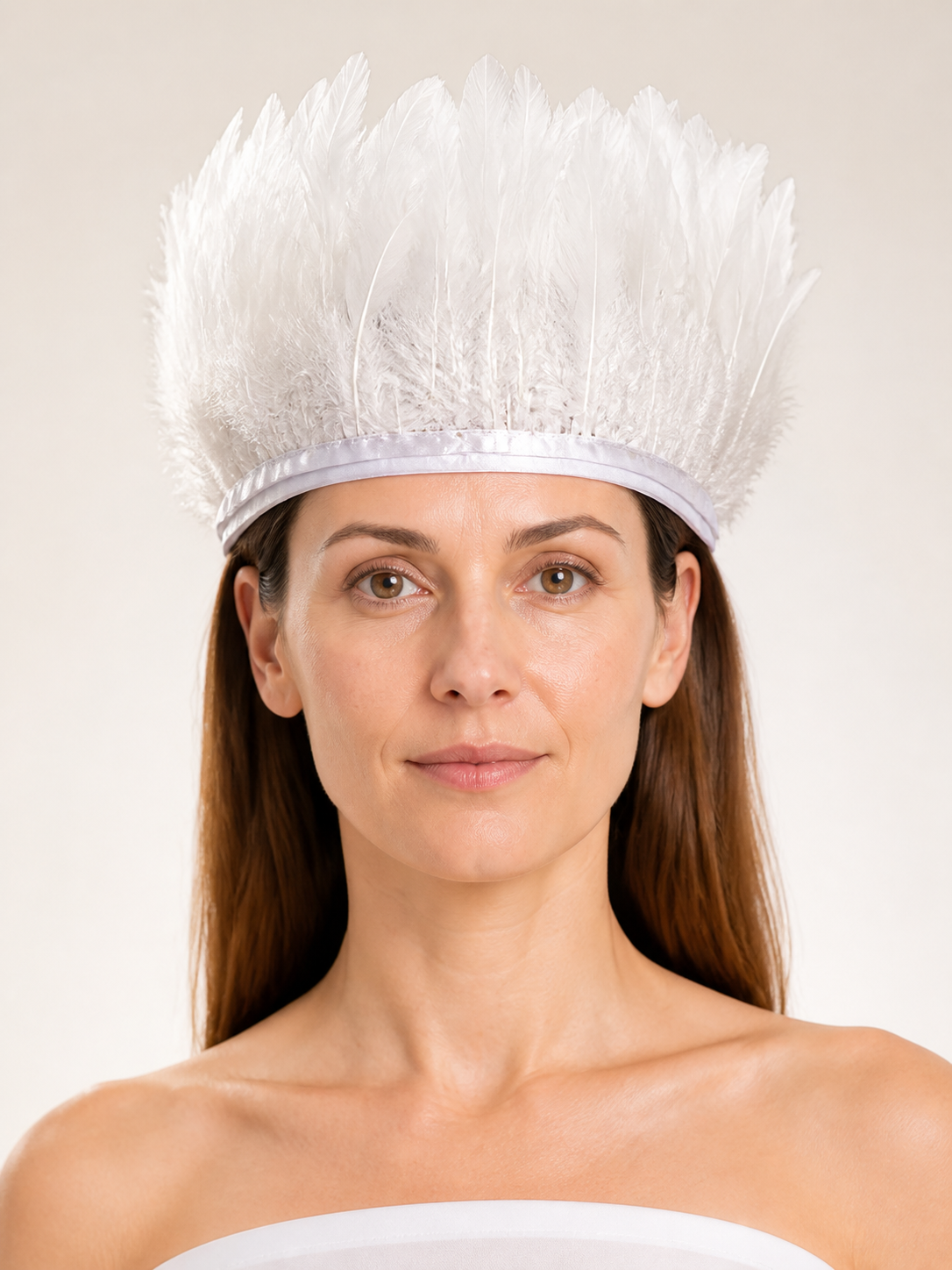 White feather headpiece shown close up from the front, with tall separated feathers and a satin-like band