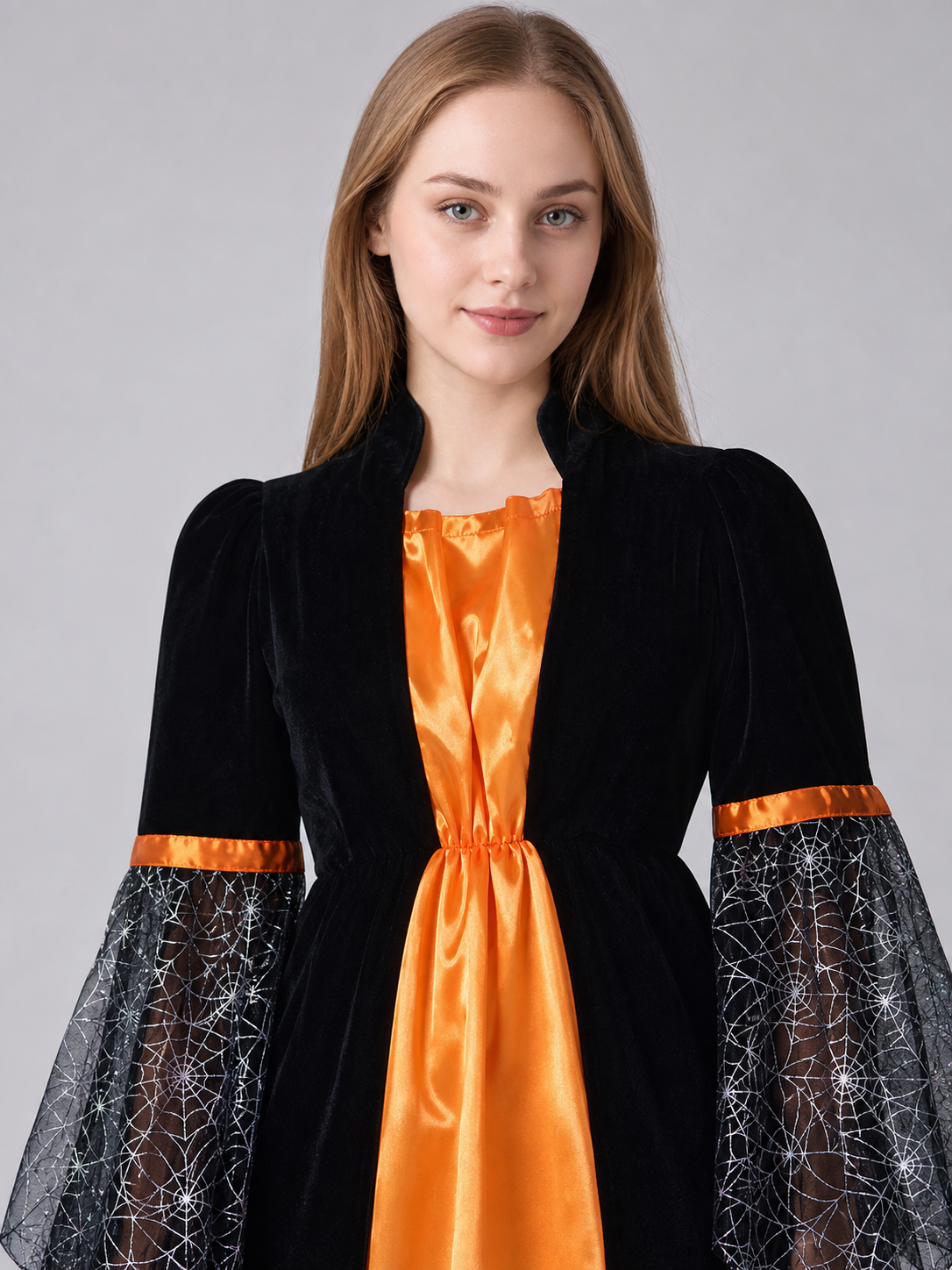 Witch-style costume set featuring a long black dress with long sleeves, a wide flared bottom, and a black pointed hat. The design uses orange, silver, and black colors. The center front of the dress features an orange decorative element, an
