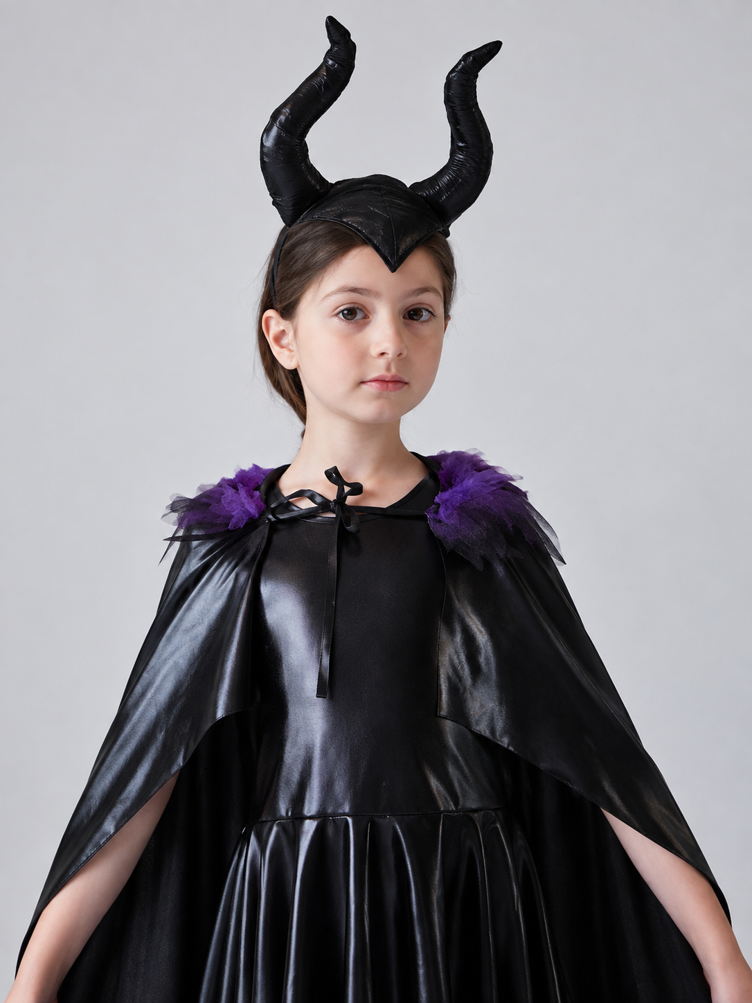 Costume: black dress, cape, headband with horns
