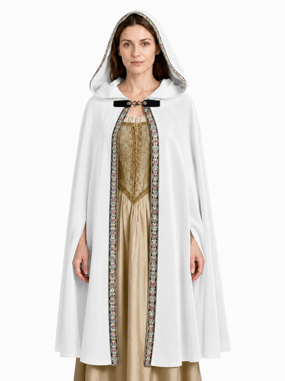 White hooded cape with colorful patterned trim and black front clasp, shown in a close full-length front view