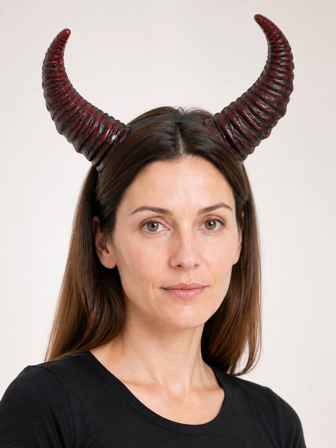 Close-up front portrait showing the red and black ridged horn headband worn on a model