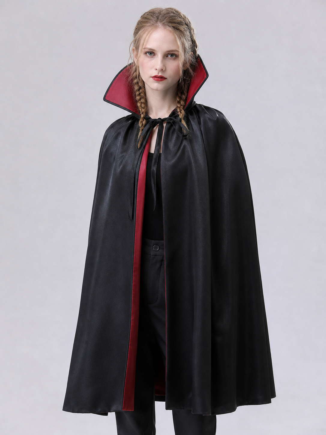 The long black cape is designed to create a vampire look for cosplay, Halloween, and stage performances. The cape is black and features a loose silhouette with long, draping panels and an opening lower edge. The upper section has a hooded o