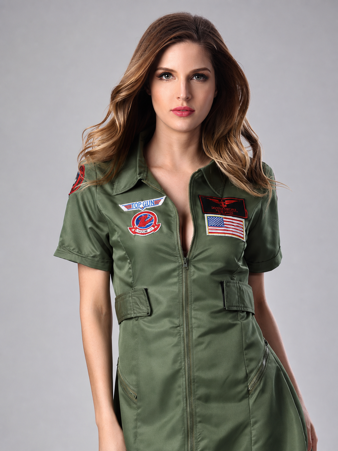 The uniform dress is made in military green and styled after professional aviation uniforms. The design is a short fitted dress with short sleeves, a notched collar, and a front zipper. Aviation-themed patches and insignia, as well as a pat